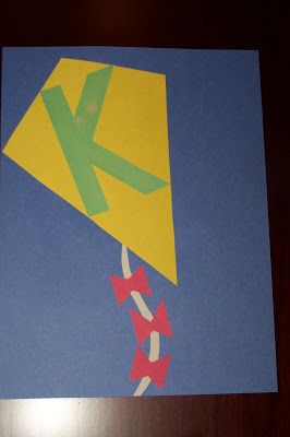 a piece of paper that has been cut out to look like a kite with the letter k on it