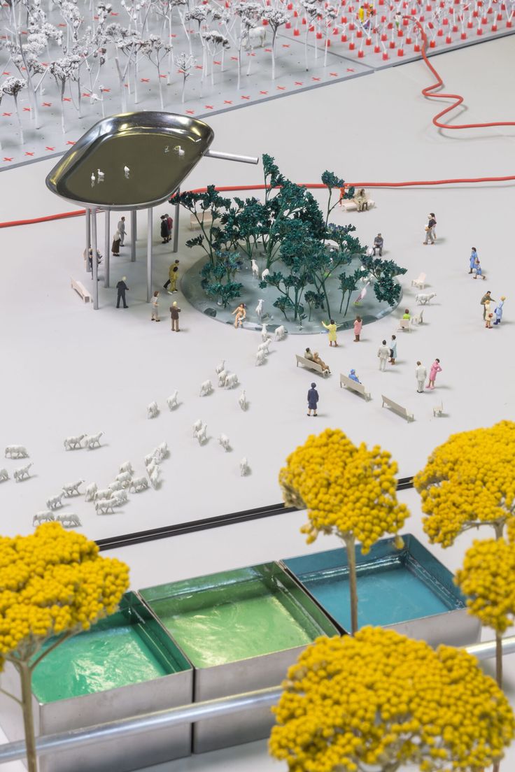 a group of people standing in front of a bunch of fake trees