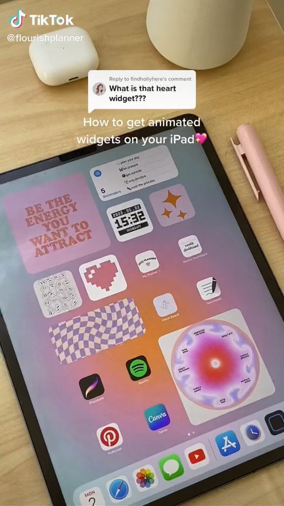 an ipad sitting on top of a wooden table next to a pen and paper holder