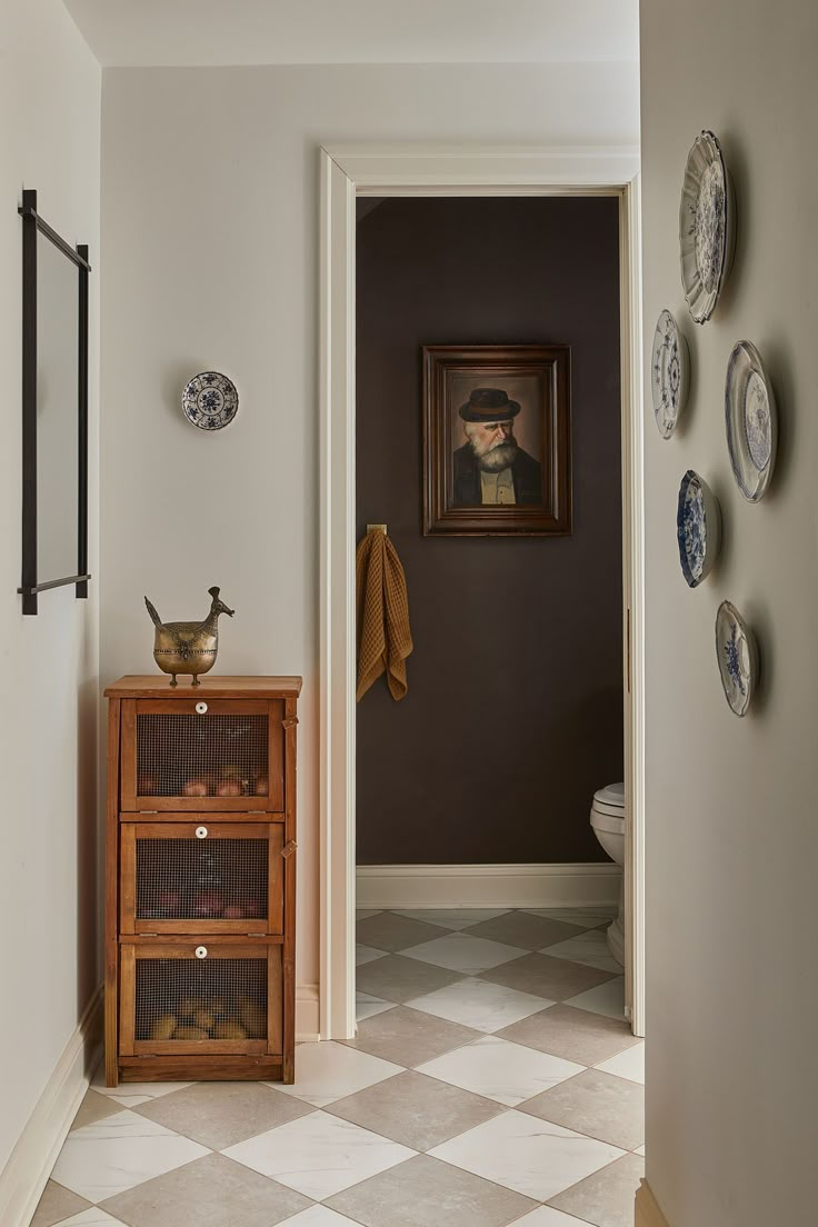 a bathroom with a checkered floor and white walls