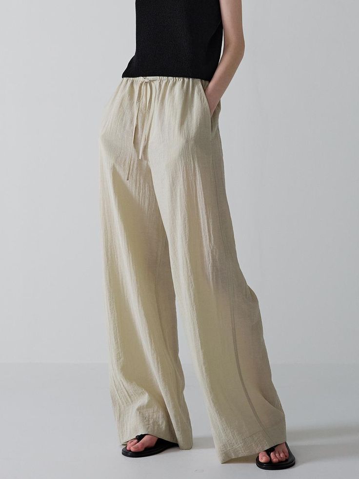 This is a trendy and modern pants by FACADE PATTERN that is made out of high quality and sturdy material. With distinctive mood of the design and modern feminine look, you can style it for your trendy daily outfit.- Soft and crispy touch of cool fabric- Relaxed wide silhouette- Adjustable string on the waistband Modern Relaxed Fit Wide Leg Pants With Elastic Waistband, Khaki Straight Cargo Pants, Modern Cotton Ankle-length Pants, Versatile Beige Cotton Pants, Modern Ankle-length Cotton Pants, Versatile Khaki Pants, Versatile Straight Khaki Pants, Chic Baggy Straight Parachute Pants, Modern High-waisted Pants With Elastic Waistband