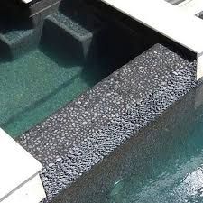 an outdoor swimming pool with steps leading up to the water's edge and green algae growing on it