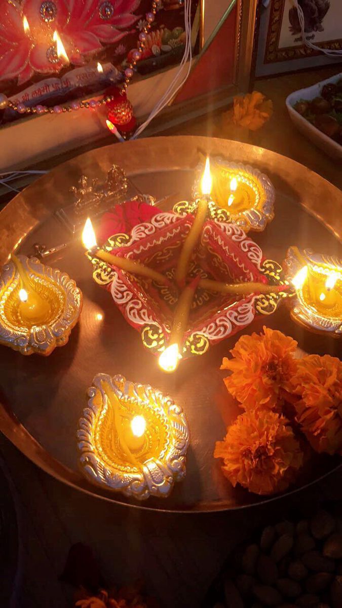 candles are placed on a tray with flowers