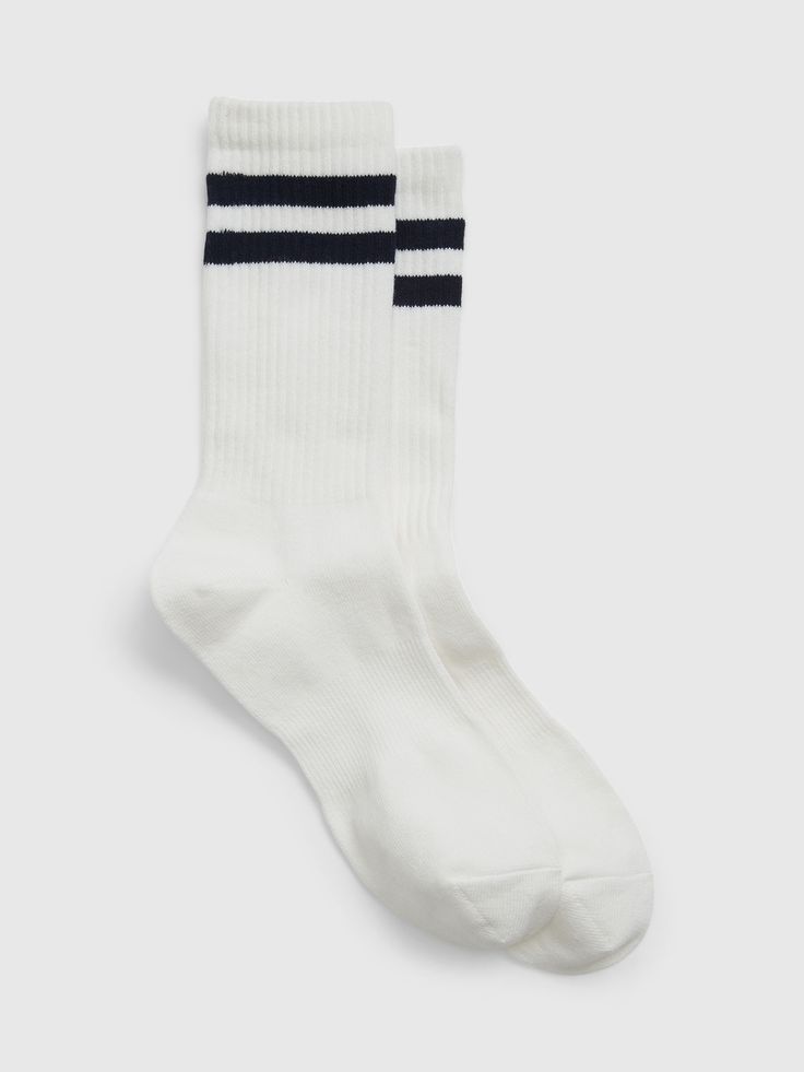 Soft knit crew socks.  Double stripes and ribbing at top.  Reinforced toe and heel.  This product was made in a factory that invests in gender equality and women’s empowerment.  Through RISE Reimagining Industry to Support Equality) and Gap Inc. ’s program P. A. C. E.  Personal Advancement & Career Enhancement), we support people who make our clothes to build the skills, knowledge, confidence, and resilience needed to advance in work and life.  Learn more here.  S/M: 20 cm toe length, 26 cm leg White Cotton Mid-calf Socks, White Mid-calf Cotton Socks, White Ribbed Cotton Socks, Striped Cotton Socks For Winter, Arch Logo, Gap Logo, Support People, Striped Socks, Tube Socks