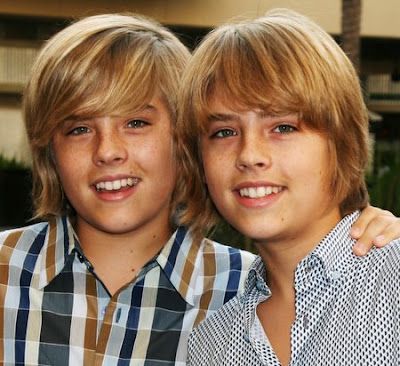 two young boys are posing for the camera with their heads turned to look like they're smiling