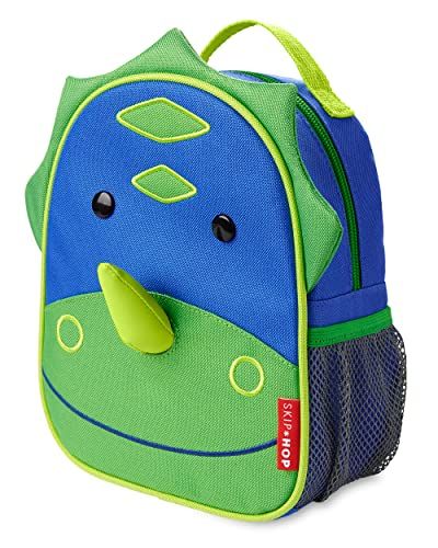 a blue and green backpack with a face on the front, attached to it's side