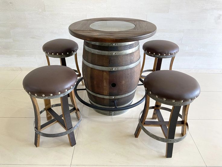 four stools and a table made out of wine barrels