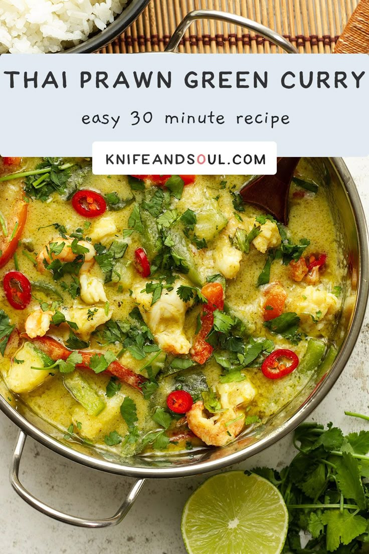 thai green curry in a pan with limes and cilantro on the side