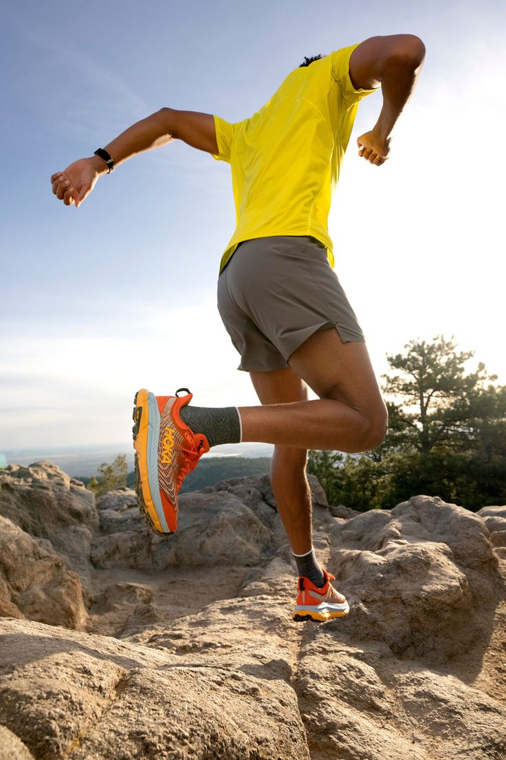 a man running on top of a rocky hill