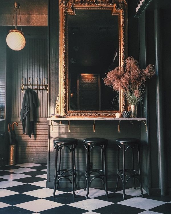 two stools and a mirror in a room