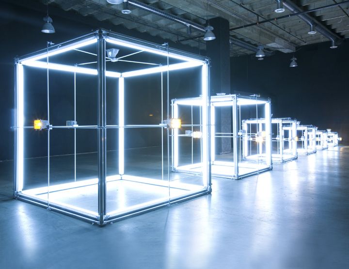 a group of glass cubes sitting inside of a building with lights on each side