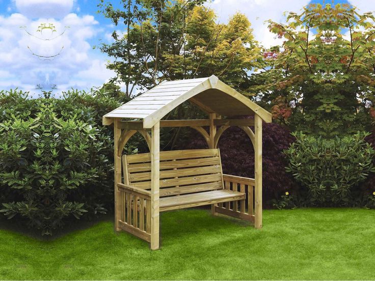 a wooden bench sitting in the middle of a lush green field next to bushes and trees