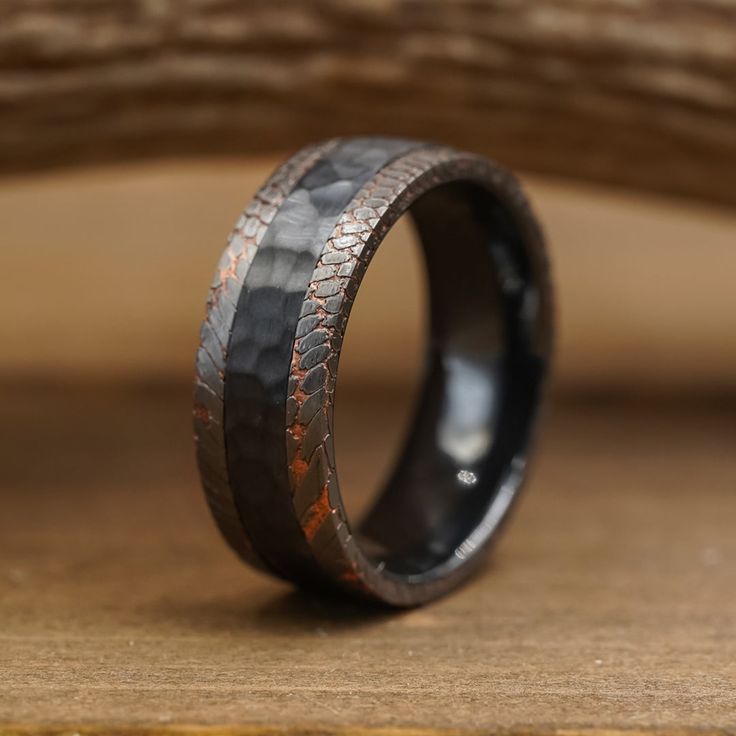 a wedding band made out of black and brown wood