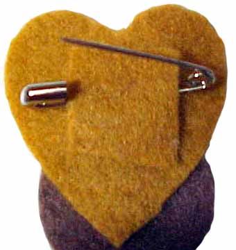 a heart shaped brooch with two pins attached to it's back and side