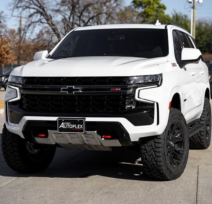 a white truck is parked in a parking lot