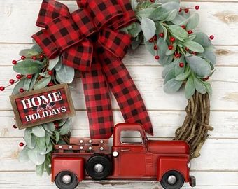 a christmas wreath with a red truck on it