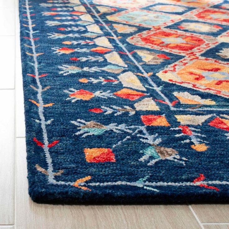 a blue rug with an orange and red design on it