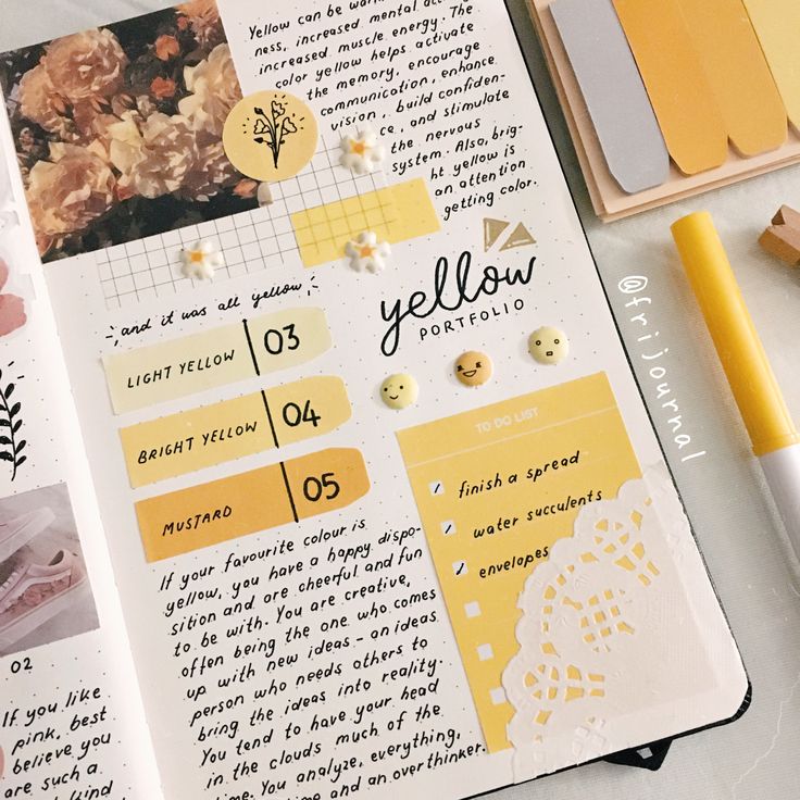 an open notebook with yellow stickers on it and some other items next to it