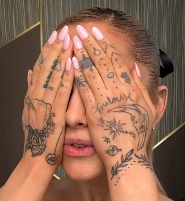 a woman with tattoos covering her eyes