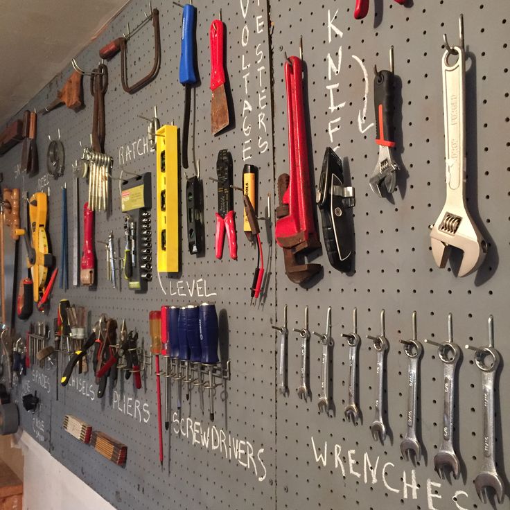 there are many tools hanging on the wall