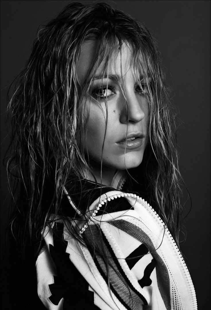 a black and white photo of a woman with wet hair