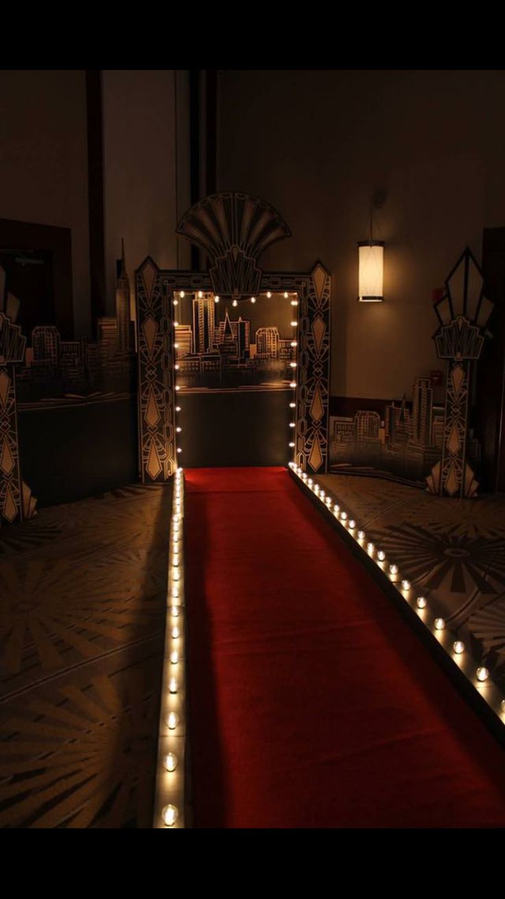 a red carpeted aisle with lights on it