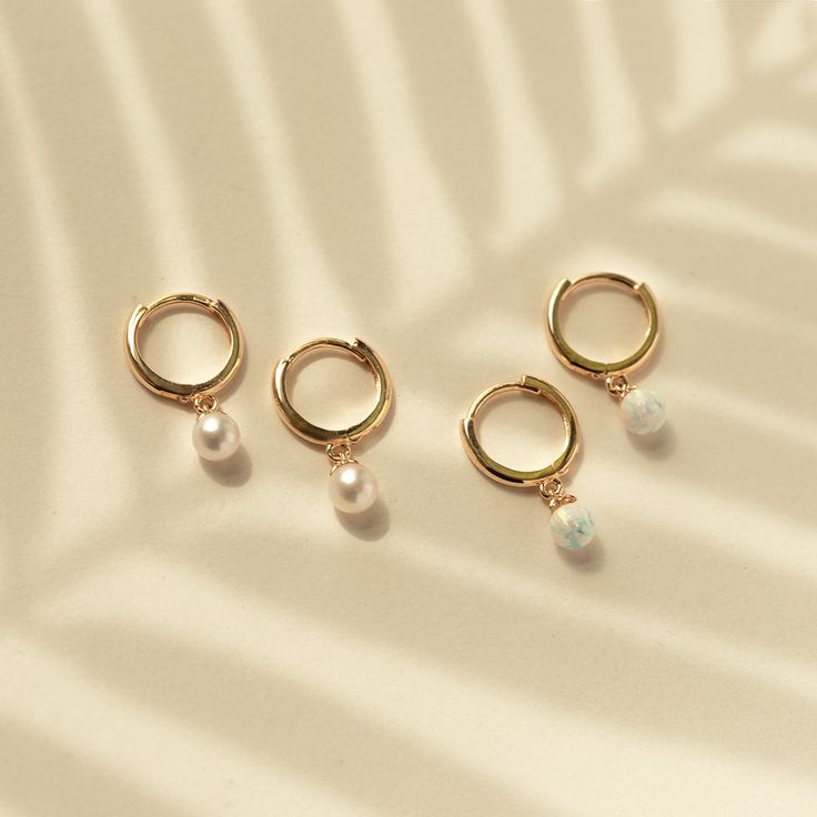 This 14K Gold Small Hoop earrings feature a tiny dangling Pearl. Solid Gold makes these pair tarnish-free! Smaller in size-Great for smaller lobes or second piercings. 14K Gold Freshwater Pearls Hypoallergenic, lead and nickel free Thickness 1.6mm Diameter Sizes: Inside 8mm Pearl Diameter: 4mm Click Snap closure #ES084 Second Piercings, Gold Small Hoop Earrings, Second Piercing, Small Hoop Earrings, Opal Beads, Snap Closure, Freshwater Pearls, Solid Gold, Piercings