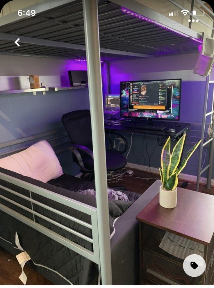 there is a bunk bed in the room with purple lighting and a computer on the desk