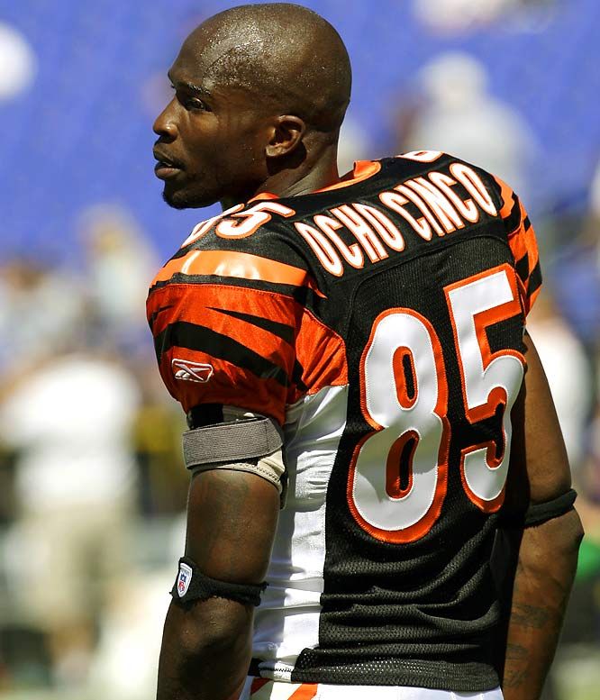 a close up of a football player wearing an orange and black uniform with the number 50 on it