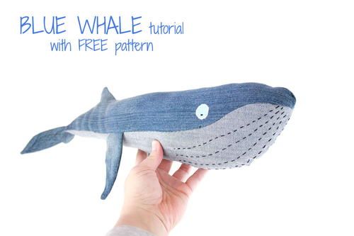 a hand holding a blue whale stuffed animal with free pattern on the front and side