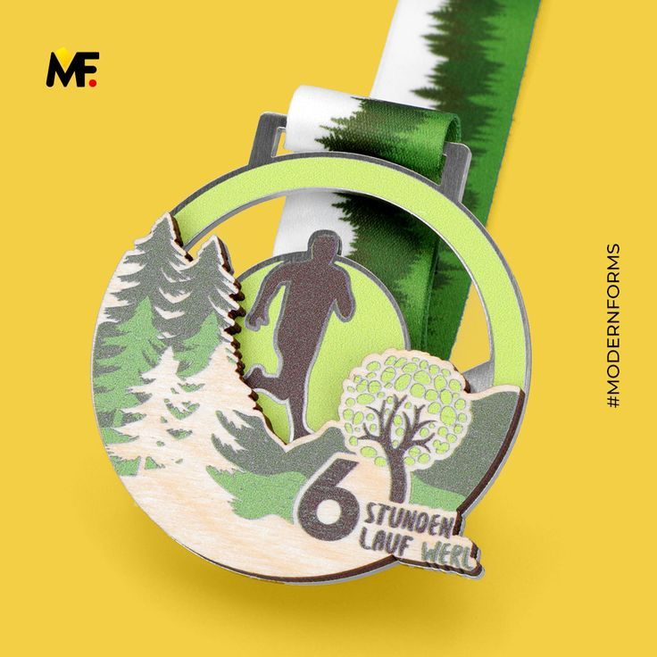 a medal with a green ribbon around it and a man running in the woods behind it