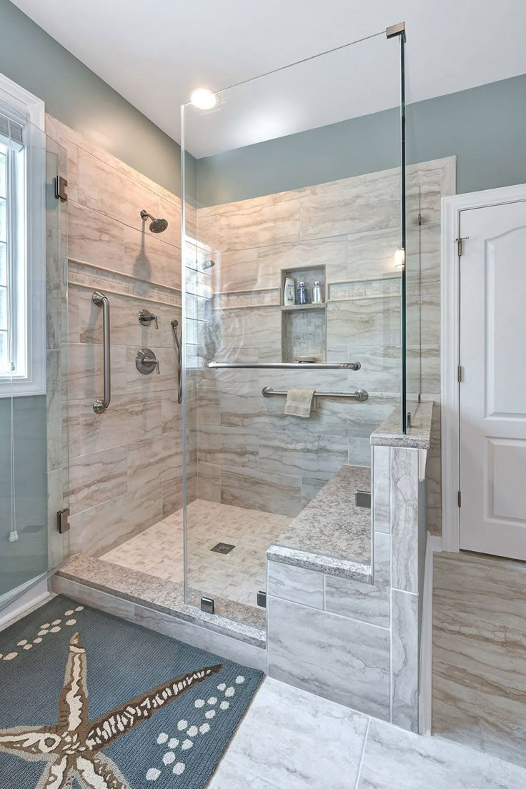 a bathroom with a walk in shower next to a window