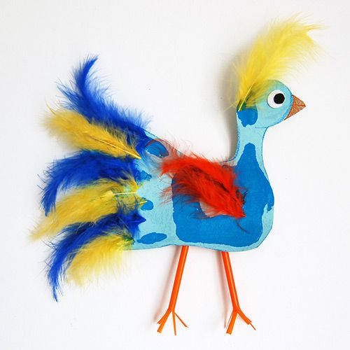 a blue and yellow bird with feathers on it's body, standing up against a white background