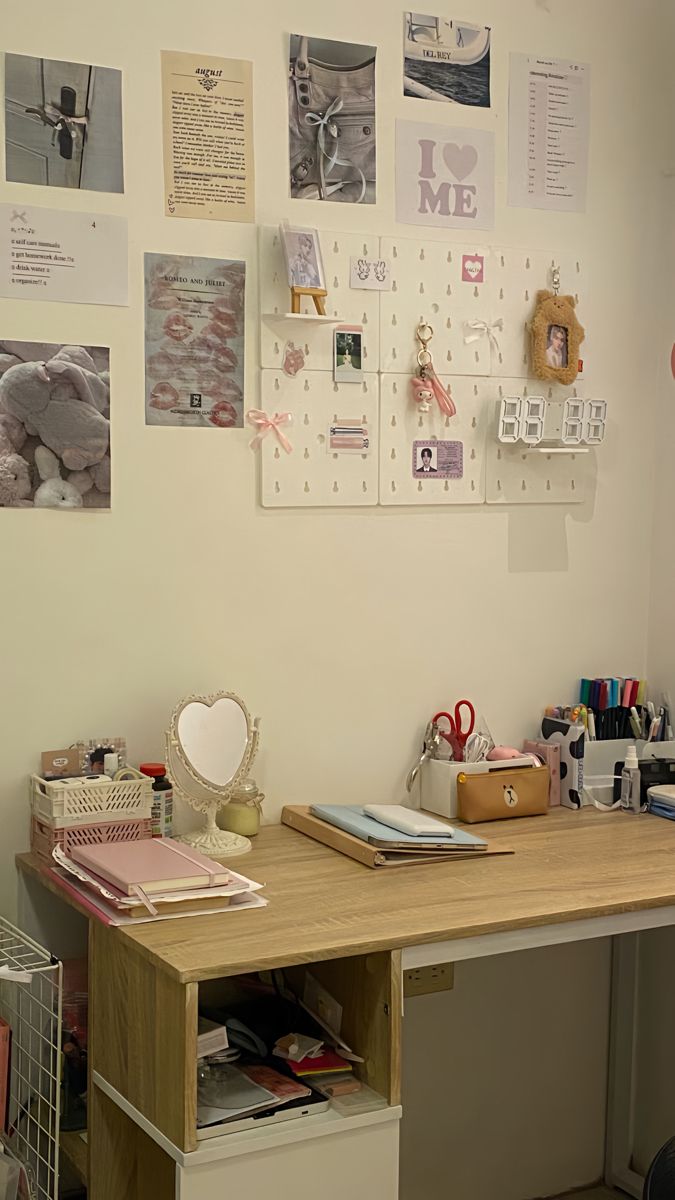 a desk with many items on it in front of a wall full of pictures and magnets