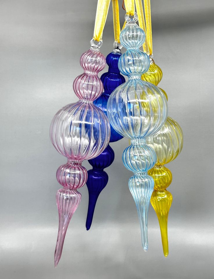 multicolored blown glass ornaments hanging from hooks