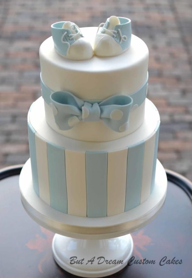 a three tiered cake with blue and white stripes