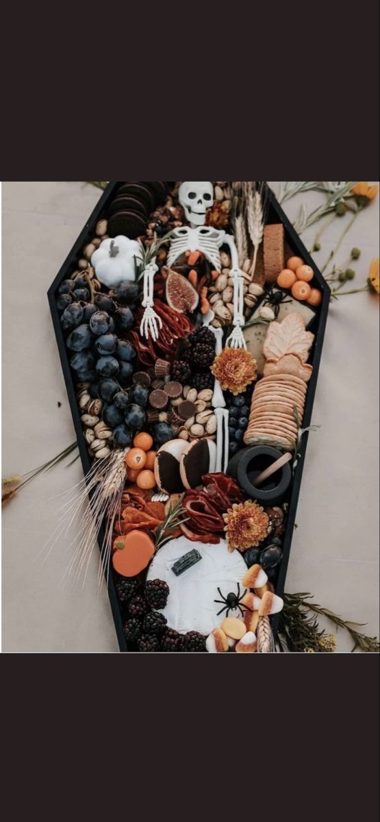 a table topped with halloween food and decorations