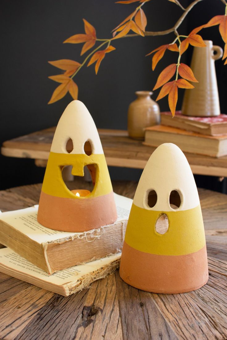 two egg shaped objects sitting on top of a wooden table