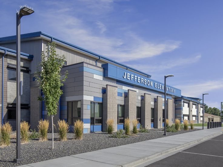 the exterior of a commercial building with blue and gray paint on it's side