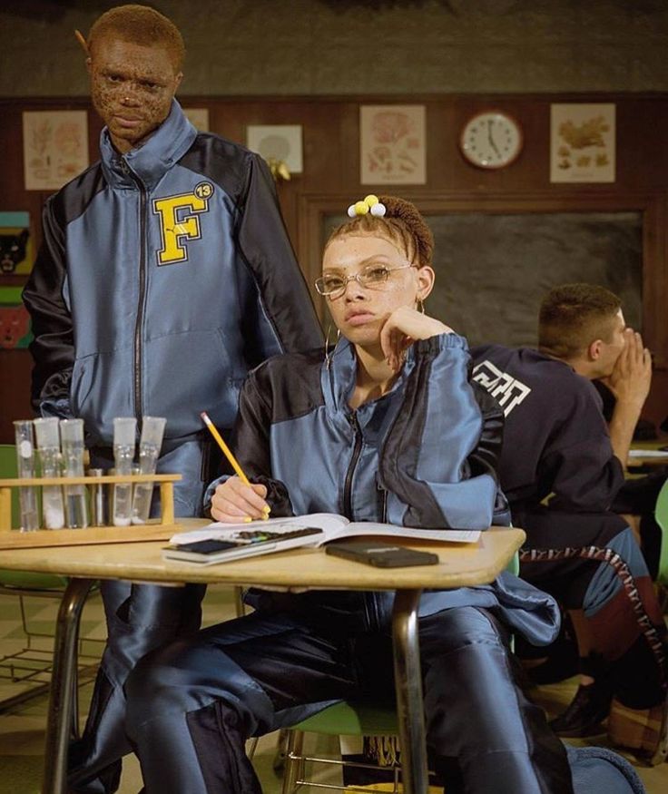 two people sitting at a table in front of each other with glasses on their heads