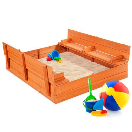 a wooden sandbox with an umbrella and beach ball