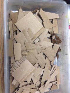 a plastic container filled with lots of cardboard pieces