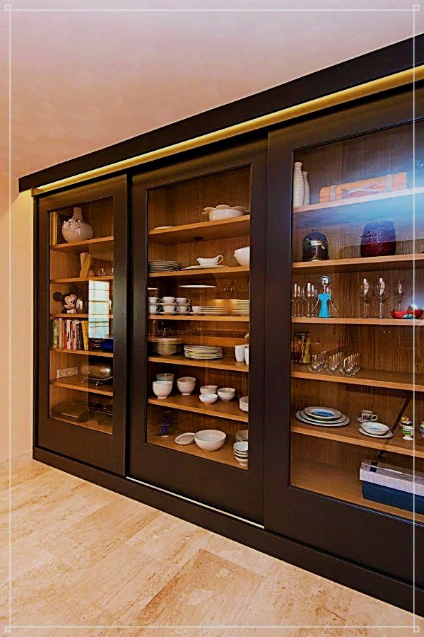 an empty display case with glass doors on the front and back sides filled with dishes