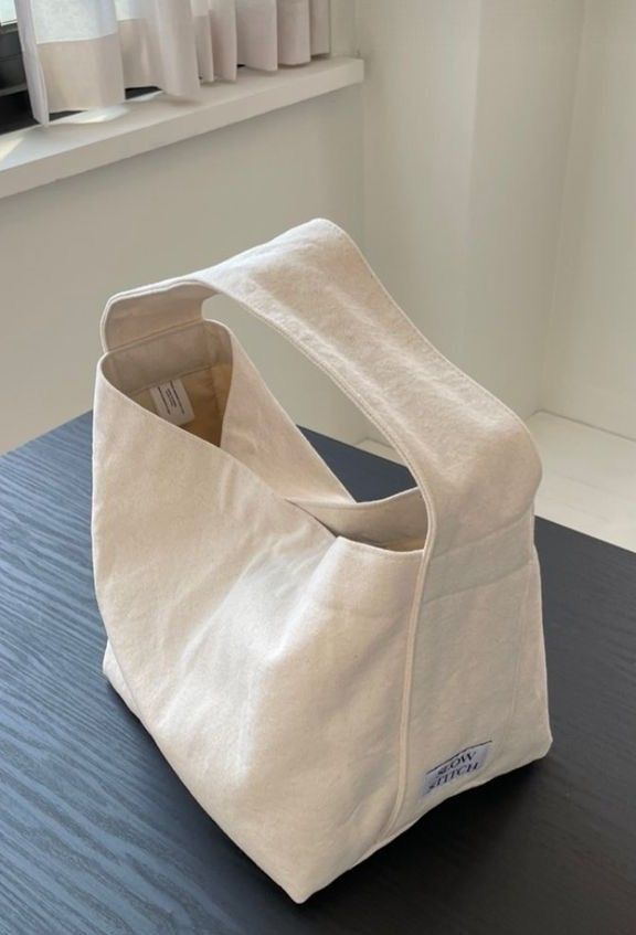 a white bag sitting on top of a wooden table