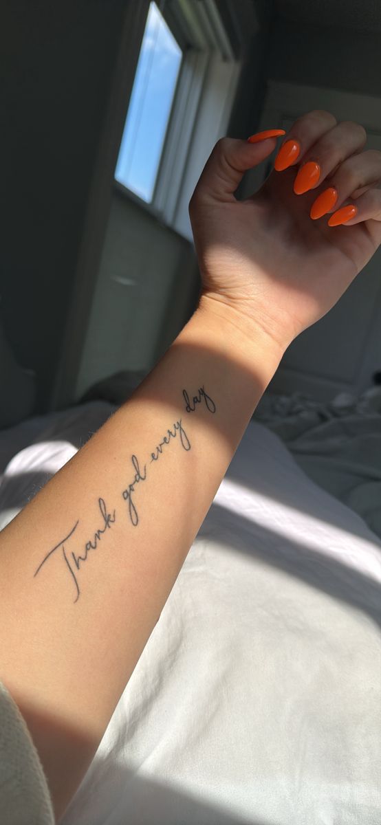 a woman's arm with the words thank you on it