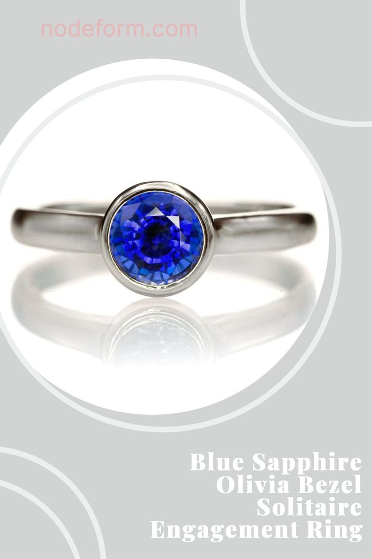 a ring with a blue sapphire in the center and an inscription below it that reads, engagement