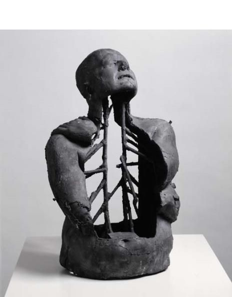 a black and white photo of a sculpture with the back of a man's head