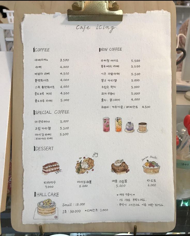 a menu on a clipboard with chinese writing and images of food items in it