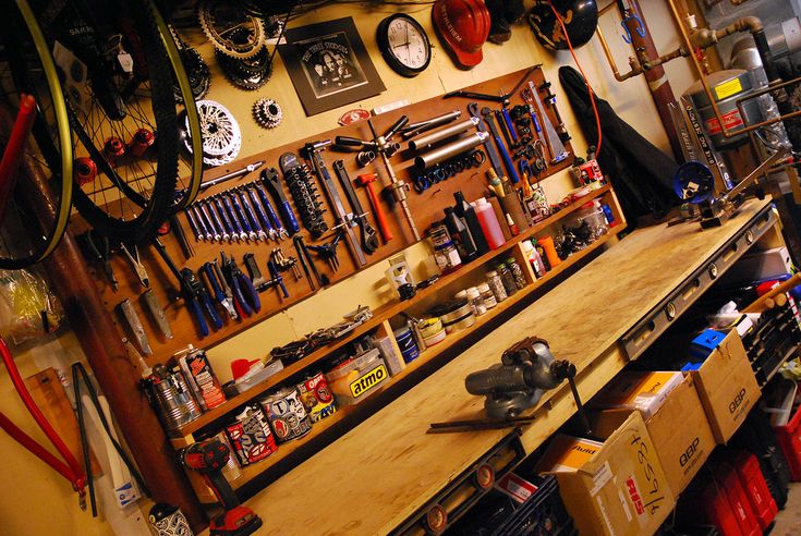 a room filled with lots of tools and assorted things on the wall above it