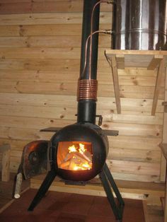 a wood burning stove inside of a wooden cabin with red border around the fire place